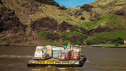 Cargo of the Aranui 5 South Sea cruise being unloaded at the coast of Marquesas Islands, French Polynesia