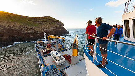 Passengers on deck of the Aranui 5 South Sea cruise at Marquesas Island of Ua Huka, French Polynesia